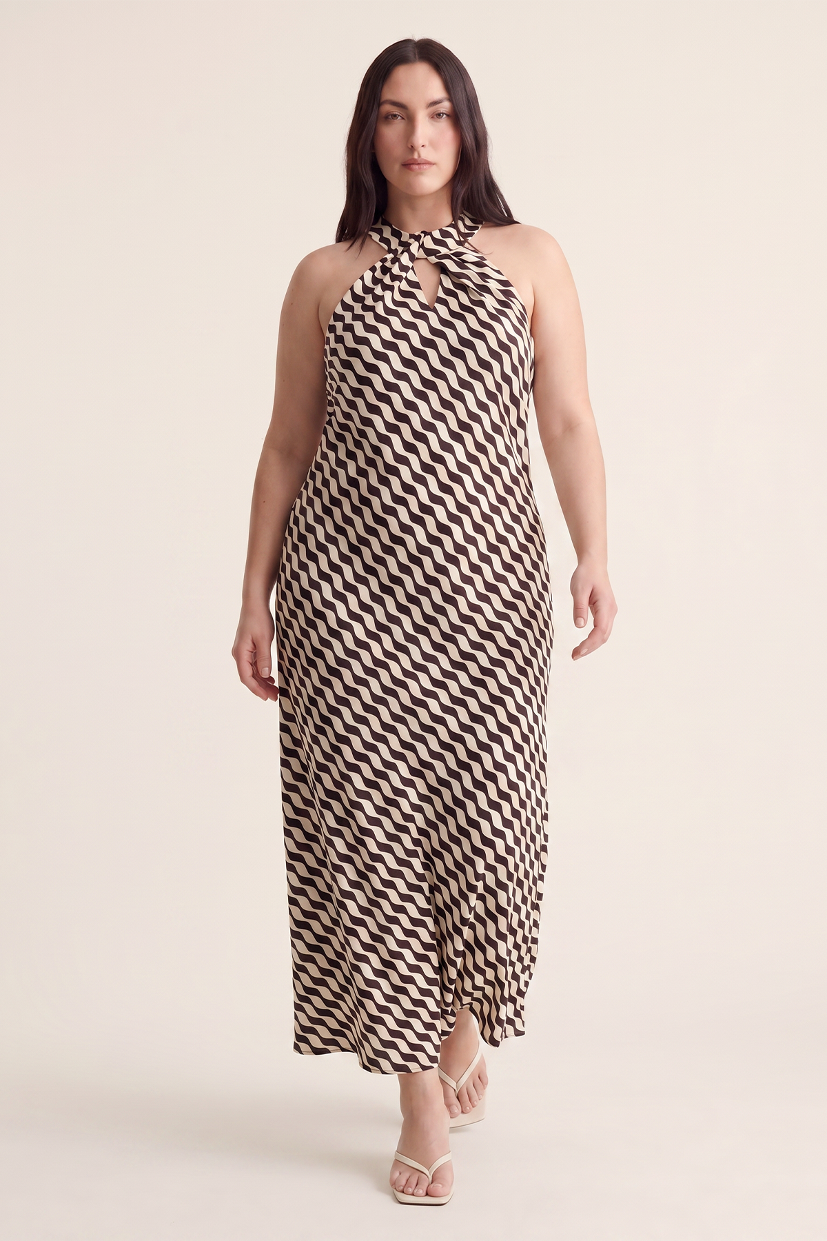 Plus-size woman in a geometric print halter maxi dress, showcasing a large size dress style.